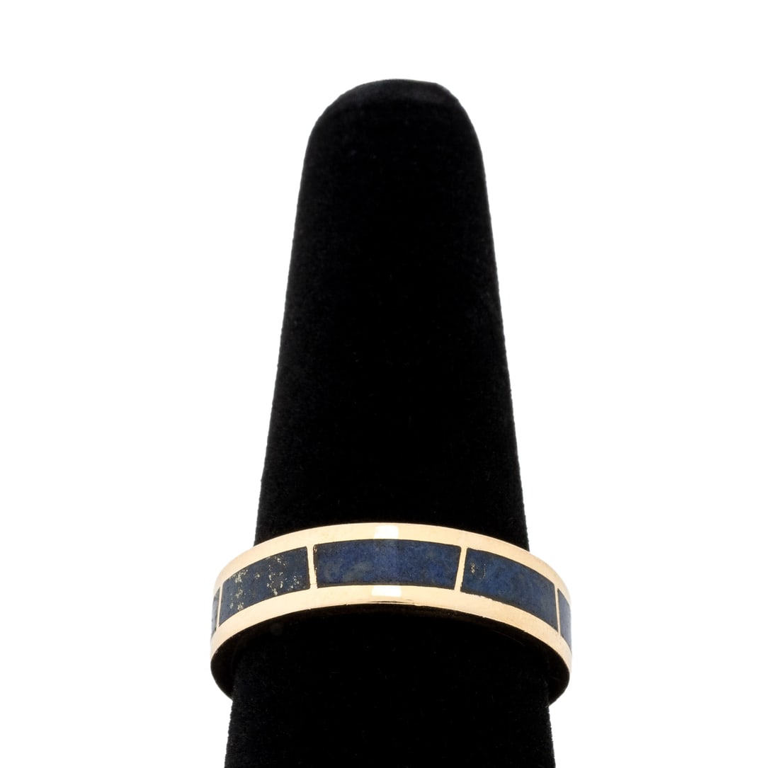 14K Yellow Gold Lapis Lazuli Band Ring: 14K Yellow Gold Lapis Lazuli Band Ring, brightly polished, featuring eight inlaid lapis panels, marked: "14K". Measuring approx. US size 9 1/2, band width 5.5 mm., 4.0 dwt. Provenance: From a New York