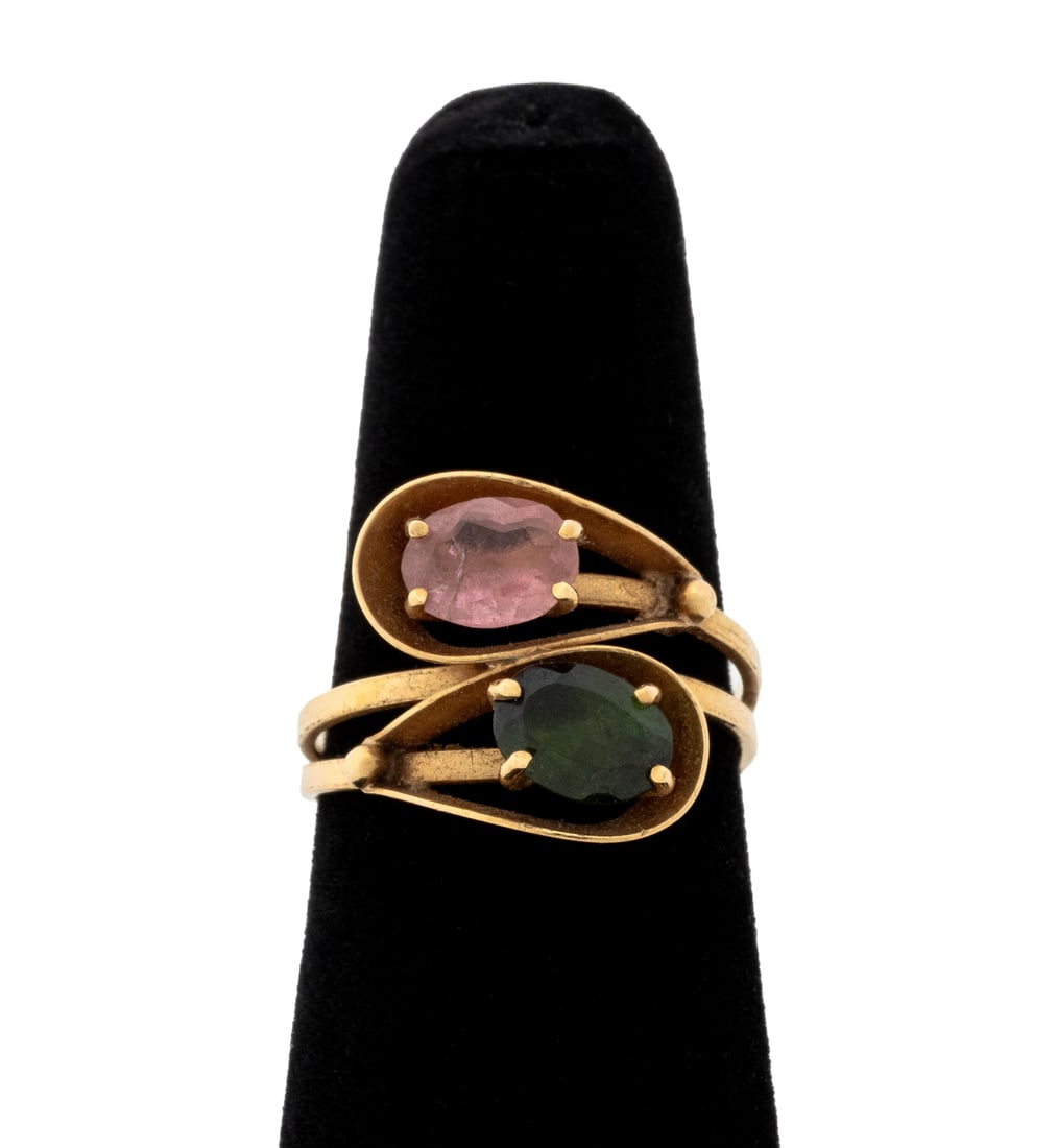 18K Yellow Gold Tourmaline Bypass Ring: 18K Yellow Gold Rubellite and Verdelite Tourmaline By-Pass Ring, featuring two prong set oval brilliant tourmalines weighing a total of approx. 1.30 carats, marked: "795 MG 750". Measuring approx. US