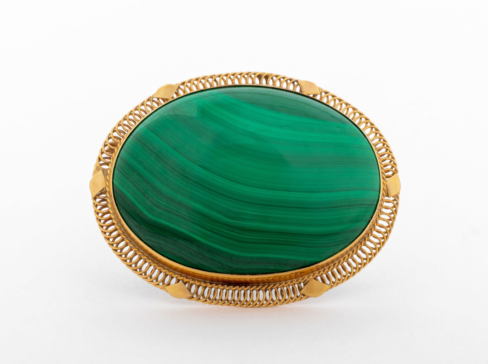 14K Yellow Gold Malachite Brooch Pendant: 14K Yellow Gold Malachite Brooch Pendant, featuring one bezel set oval malachite cabochon, weighing approx. 75.00 carats, worn as brooch with pinstem, joint and catch, worn as pendant with fixed
