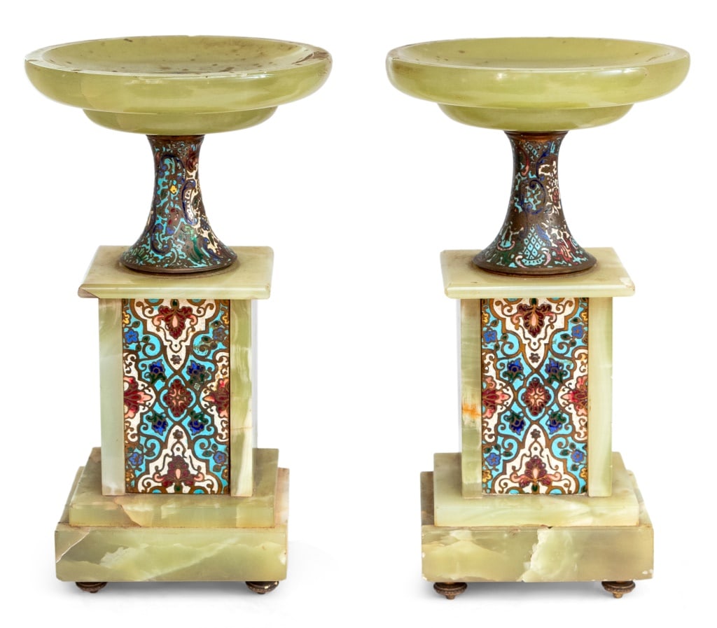 French Onyx and Champleve Enamel Tazze, Pair: Pair of French Onyx and Champleve Enamel Tazzas, early 20th century, each of typical form, with enameled stands and panels on toupie feet. 10" H x 4.25" W x 3.5" D. Keywords: Sculpture, Carving, Ename