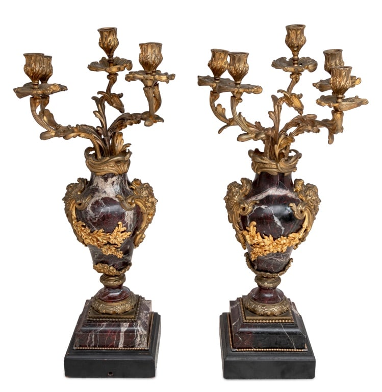 Louis XV Style Ormolu Mounted Marble Candelabra, 2: Pair of Louis XV Style Ormolu Mounted Red Veined Marble Five-Branch Candelabra, late 19th century, each of vase shape with Bacchus masque head and floral swag mounts, on wood plinths. 24.75" H x 10"
