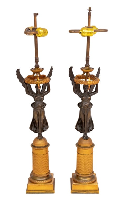 French Empire "Winged Victory" Bronze Lamps, Pair: Pair of French Empire "Winged Victory" Patinated and Gilt Bronze Figural Table Lamps, circa 1830 and later mounted, each with a standing figure of Victory upholding a wreath, on a tapering cylinder