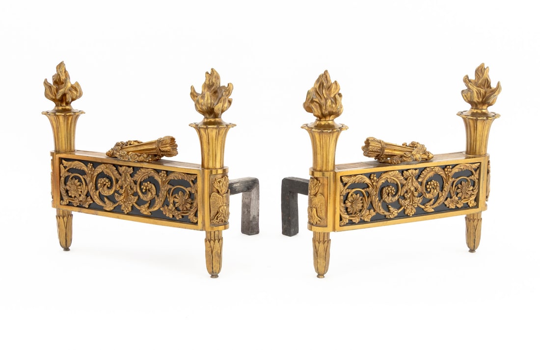 Louis XVI Style Gilt Brass Chenets, Pair: Pair of Louis XVI Style Gilt Brass Chenets, each with flaming urns and wreath above pierced garland frieze on acanthus leaf tapered legs. 11" H x 12" W x 9.5" D. Provenance: From an Upper East Side