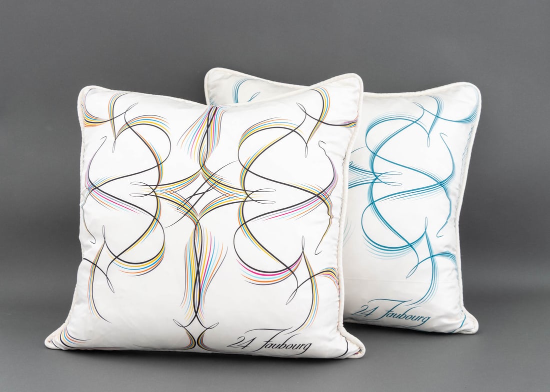 Hermes "24 Faubourg" Silk Pillows, 2: Two Hermes "24 Faubourg" Silk Pillows, in blue and rainbow with down goose feather pillows. 25" H x 25" W x 8" D. Provenance: From a Long Island Estate. Keywords: Cushions, Designer, Fabric Art,