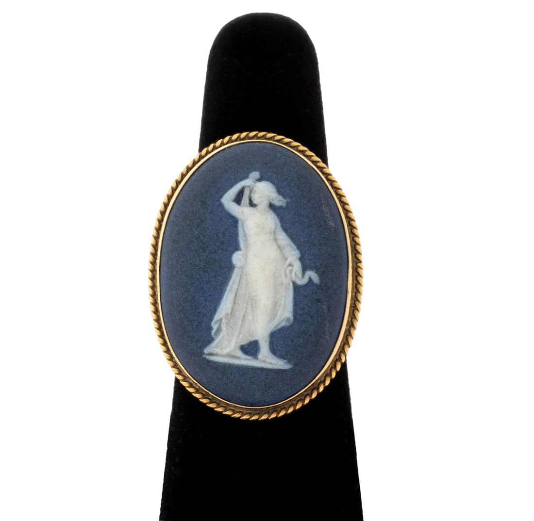 Wedgwood 14K Yellow Gold Cameo Solitaire Ring: Wedgwood 14K Yellow Gold Cameo Solitaire Ring, featuring one bezel set white on blue jasperware cameo depicting a winged allegorical female figure, approx. 28 x 20 mm, 14K yellow gold surfaces brightl