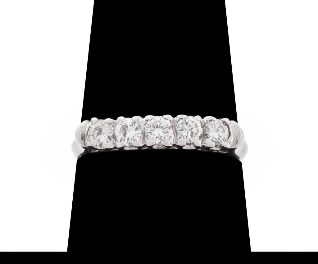 14K White Gold and Diamond Band: 14K White Gold and Diamond Band, adorned with 5 prong set round brilliant cut diamonds weighing a total of approx. 0.50 carat, marked: "14K". Measuring approx. US size 7, 1.2 dwt. Provenance: From a N