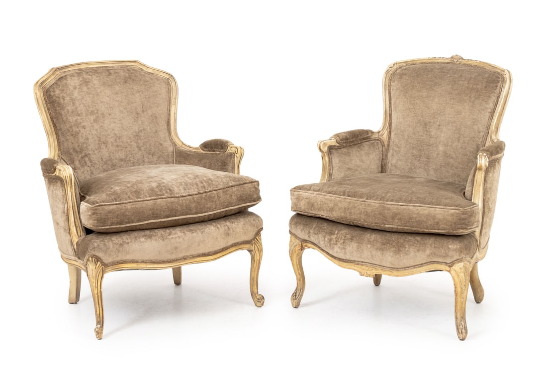Louis XV Style Bergeres, Associated Pair: Associated Pair of Louis XV Style White Painted Bergeres, one with shell form crest, each with brown upholstery on scroll form feet. Taller: 35" H x 27.5" H x 22" D; seat: 19" H. Provenance: From an E
