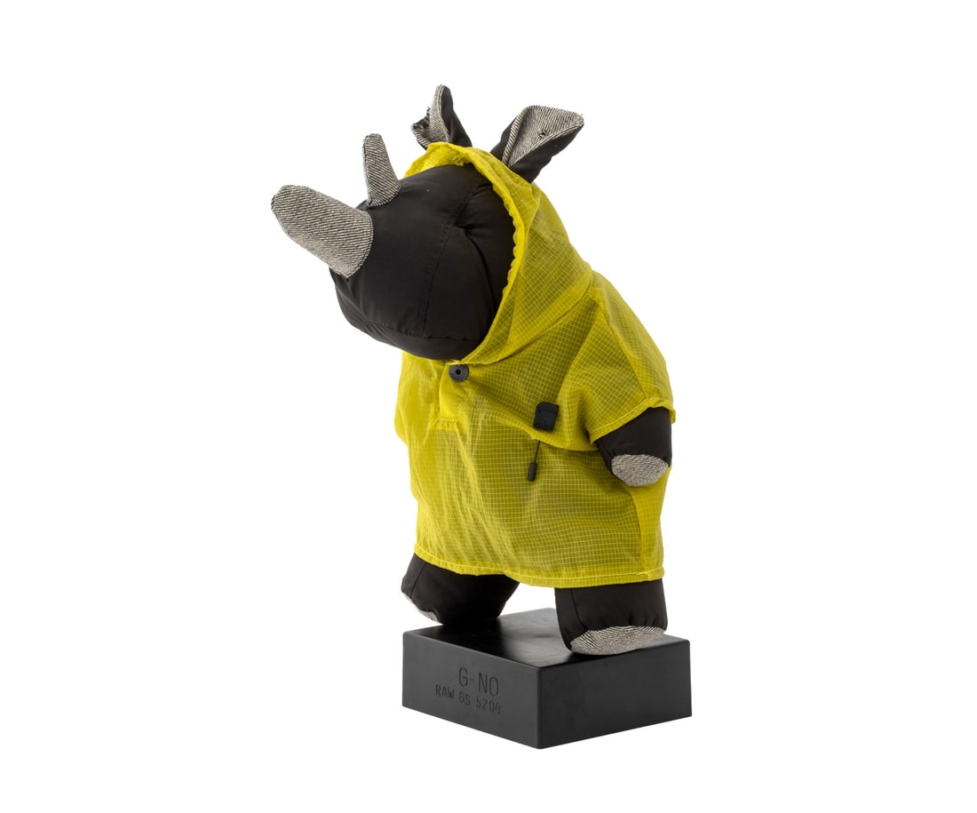 G-Star G-No Poncho Rhino Mascot Toy: G-Star G-No Poncho Black Rhino Mascot Toy, polyester with cotton details, the poncho marked "G-Star Originals Raw Denim", with original stand marked "G-NO / Raw GS 5204". Overall: 14.5" H x 7.75" W x