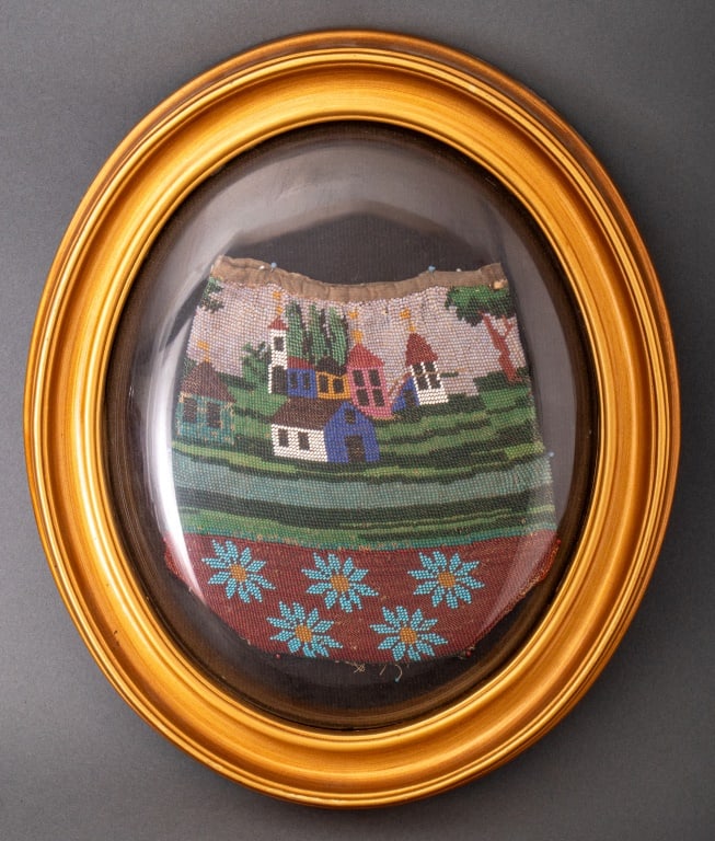 Americana Framed Folk Art Beaded Bag, 19th C.: Americana Framed Folk Art Beaded Bag, 19th century, depicting a town by a river scene over flowers, mounted in oval gold-tone frame. Bag: 6.5" H x 6" W; frame: 12" H x 10" W x 1" D. Provenance: From a