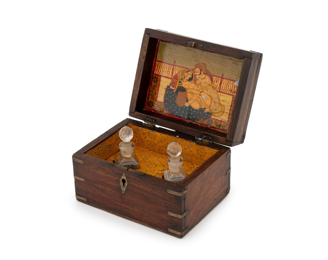 Indian Brass Inlaid Rosewood Perfume Box: Indian Brass Inlaid Rosewood Perfume Box, early 20th century, the underside of lid with hand-painted erotic miniature, the fitted interior with two glass perfume bottles. Closed: 4" H x 6.25" W x 4.75
