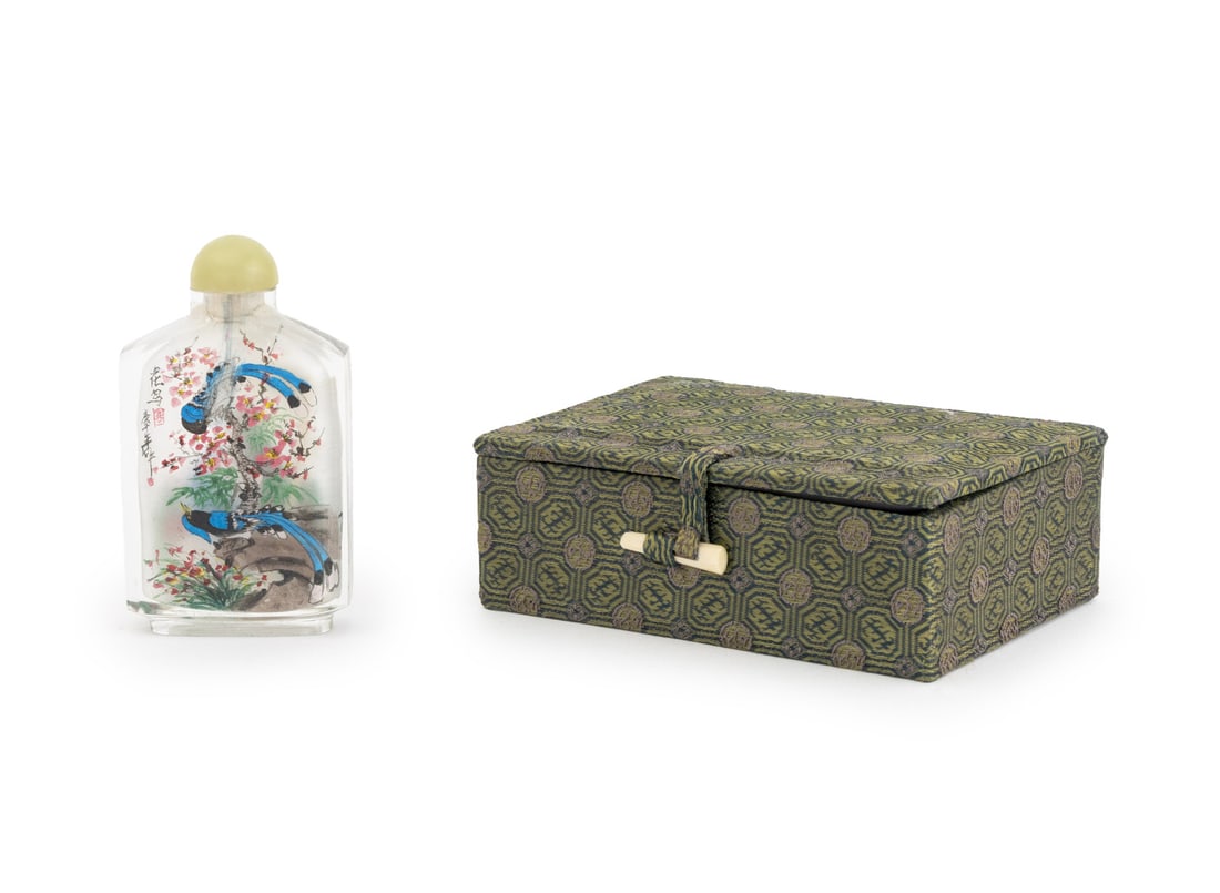 Chinese Inside Painted Glass Snuff Bottle: Chinese Inside Painted Glass Snuff Bottle, with jade stopper and hand-painted scenes of peacocks and flowers, together with fitted silk box. Bottle: 3.25" H x 2" W x 0.75" D. Provenance: From a New Yo