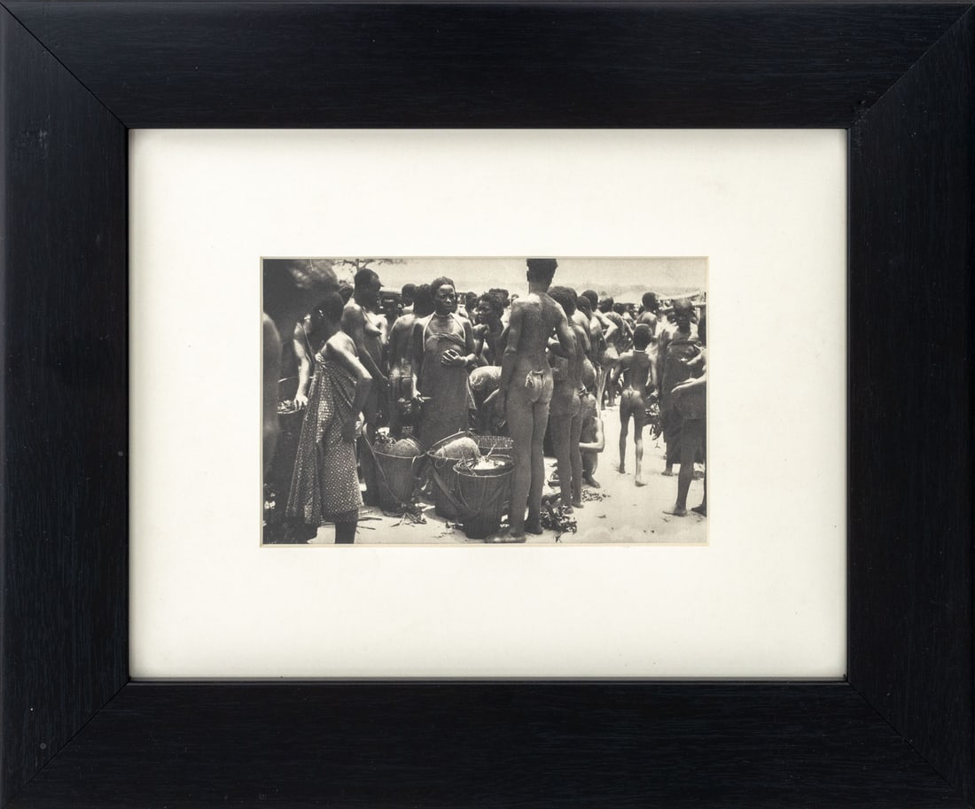 African Market Scene Offset Lithograph: African Market Scene, Offset Lithograph, ebonized wood frame. Image: 4" H x 6.25" W; frame: 11.5" H x 13.75" W x 1" D. Provenance: From a New Jersey Collection. Keywords: Photography, Prints, Multiple
