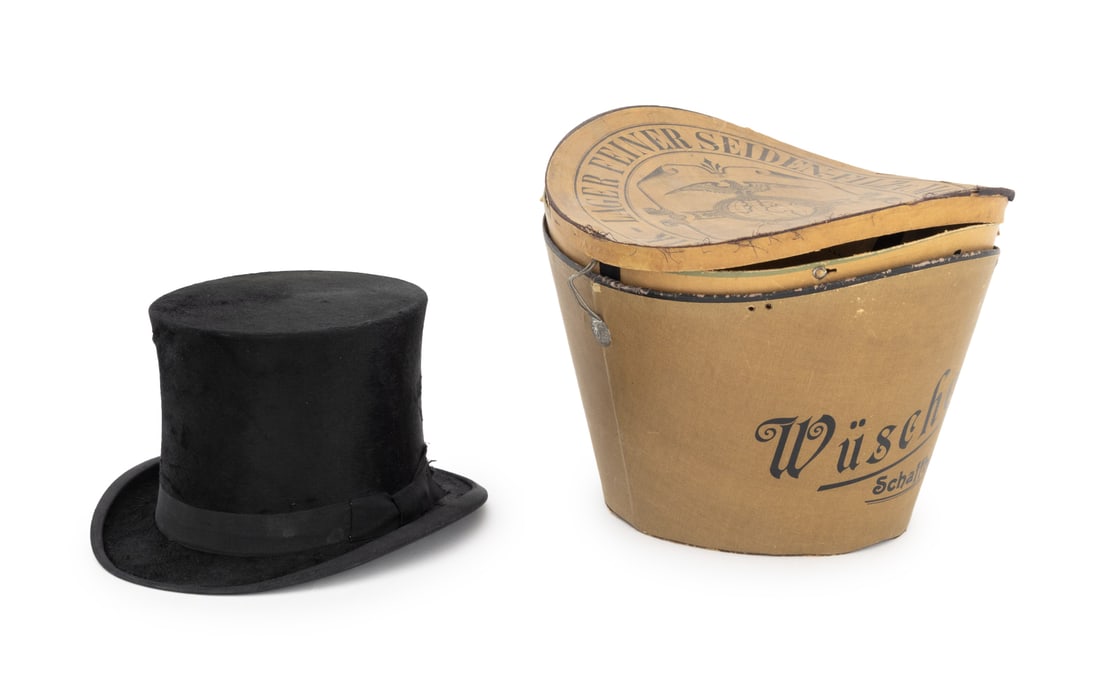 German Black Beaver Top Hat: German Black Beaver Top Hat, with gilt monogram inside, marked "Wuscher / Schaffhouse", stamped "Super Quality" to leather inner rim, size 56 / 4 1/2, with original box. Hat: 6.5" H x 11.75" W x 9.5"