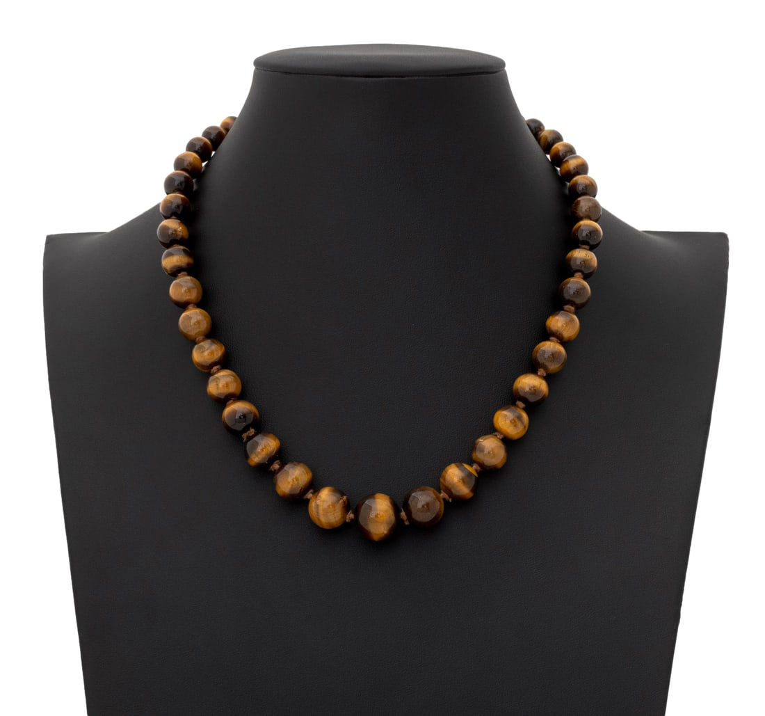 Tiger's Eye Graduated Bead 14K Gold Necklace: Tiger's Eye Graduated Bead and 14K Yellow Gold Necklace, featuring fully drilled round beads approx. 7.5 - 14.0 mm, strung on silk cord and knotted between each bead, joined by 14K yellow gold box and