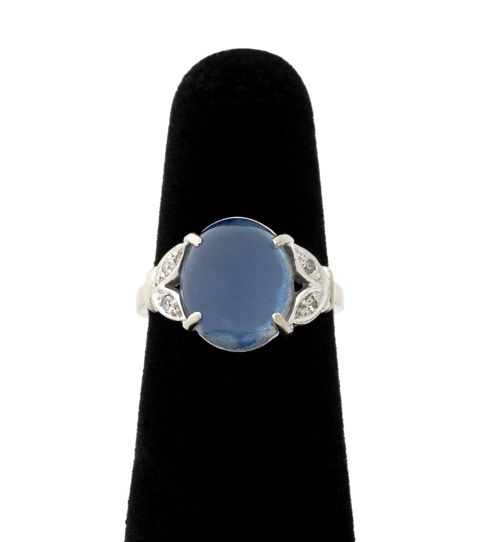 14K White Gold Star Quartz Diamond Ring: 14K White Gold Star Quartz Diamond Ring, featuring one prong set oval star colorless quartz cabochon backed with blue enamel coating weighing approx. 3.55 carats, further adorned with four bead set ro