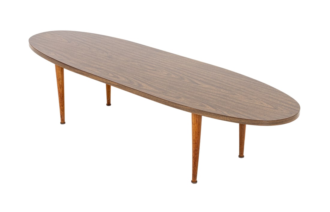 Mid-Century Modern Walnut Oval Coffee Table: Mid-Century Modern Walnut Oval Coffee Table, wood veneer top above four tapered walnut legs. 13.75" H x 60" W x 18" D. Provenance: From a Long Island, New York Estate. Keywords: Vintage Furniture, Dan