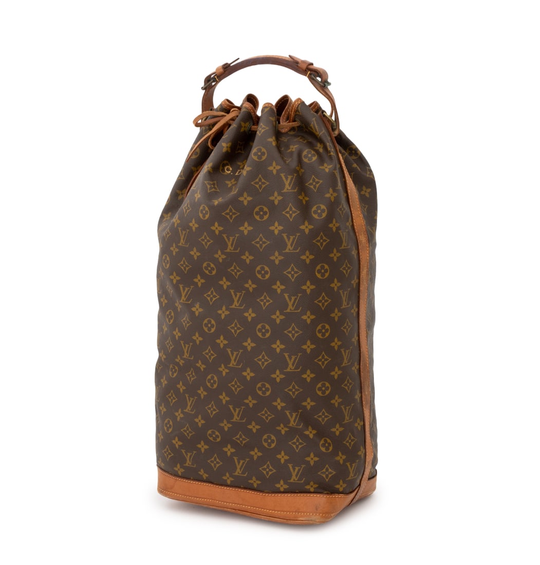 Louis Vuitton Monogram Canvas Duffel Bag: Louis Vuitton Monogram Canvas Duffel Bag, with tan leather top handle and drawstring closure, marked "Louis Vuitton" and numbered "882789". 21" L x 16" W x 7". Provenance: From an East 74th Street Est
