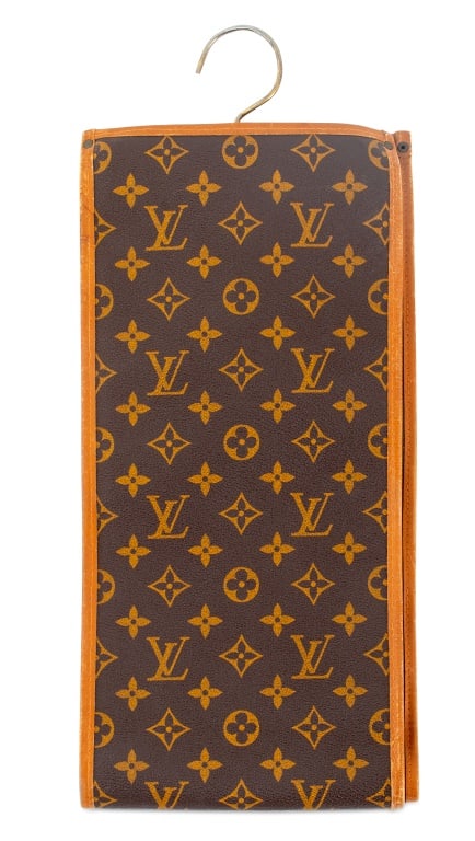 Louis Vuitton Monogram Tie Garment Bag: Louis Vuitton Monogram Tie Garment Bag, in brown leather with gold-tone metal hardware. 31.25" H x 7.25" W. Provenance: From a Central Park South Estate. Keywords: Fashion, Designer, Travel case, Stor