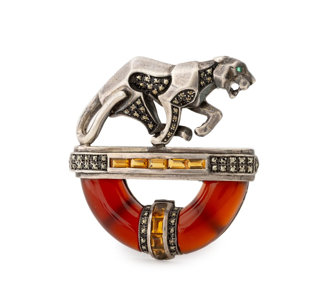 Art Deco Style Sterling & Crystal Jaguar Brooch: Art Deco Style Sterling Silver and Crystal Jaguar Pin, with a carnelian half-circle mounted with marcasite and orange amber-tone gemstones below a stylized jaguar figure with inset green crystal eye,