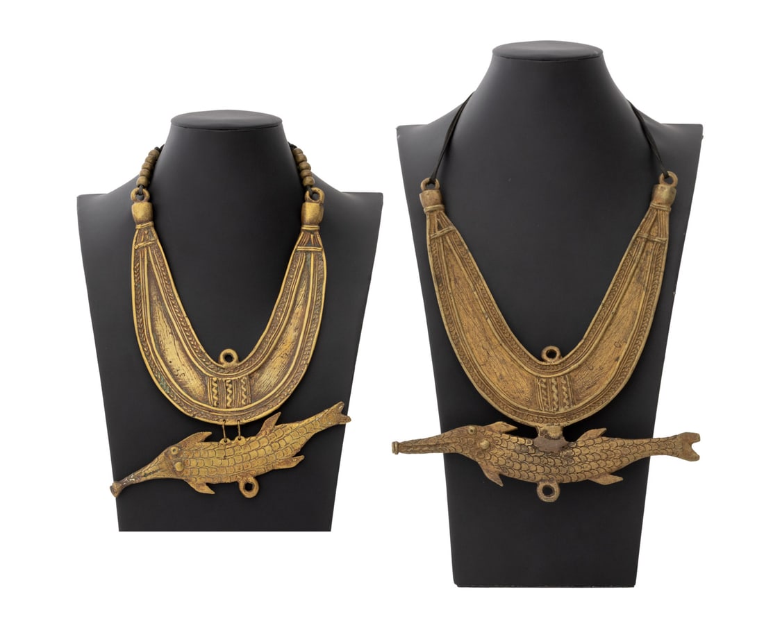 Central African Brass Mossi Fish Necklaces, 2: Central African Brass Mossi Fish Necklaces, one pendant articulated, both on black cord. Wider pendant: 9.75" L x 8.25" W. Provenance: From the Estate of Jewelry Designer Irena Corwin. Keywords: Afric