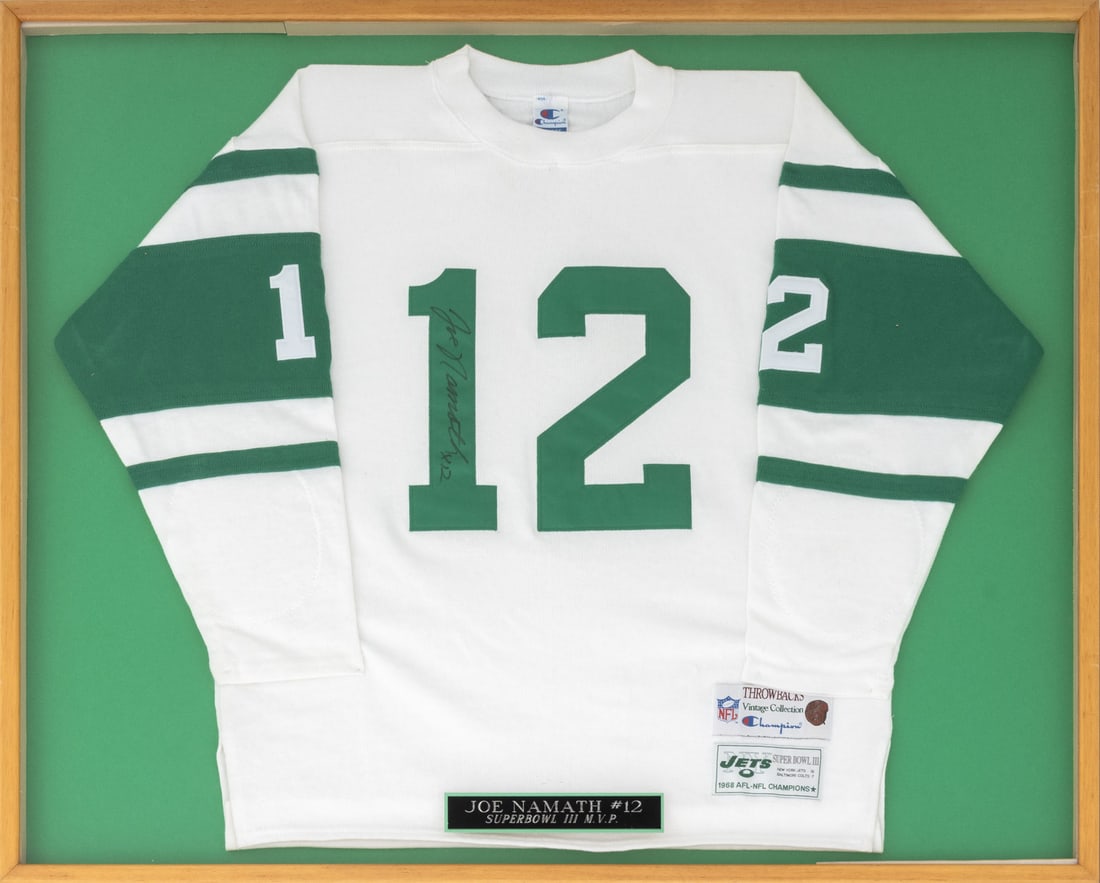 Joe Namath Signed Superbowl MVP Jets Sweatshirt: Joe Namath Signed Superbowl III MVP Jets Sweatshirt, float mounted in shadowbox frame with engraved plaque to the front. Sweatshirt: 30" H x 37" W; frame: 33.25" H x 41.25" W x 1.25" D. Provenance: