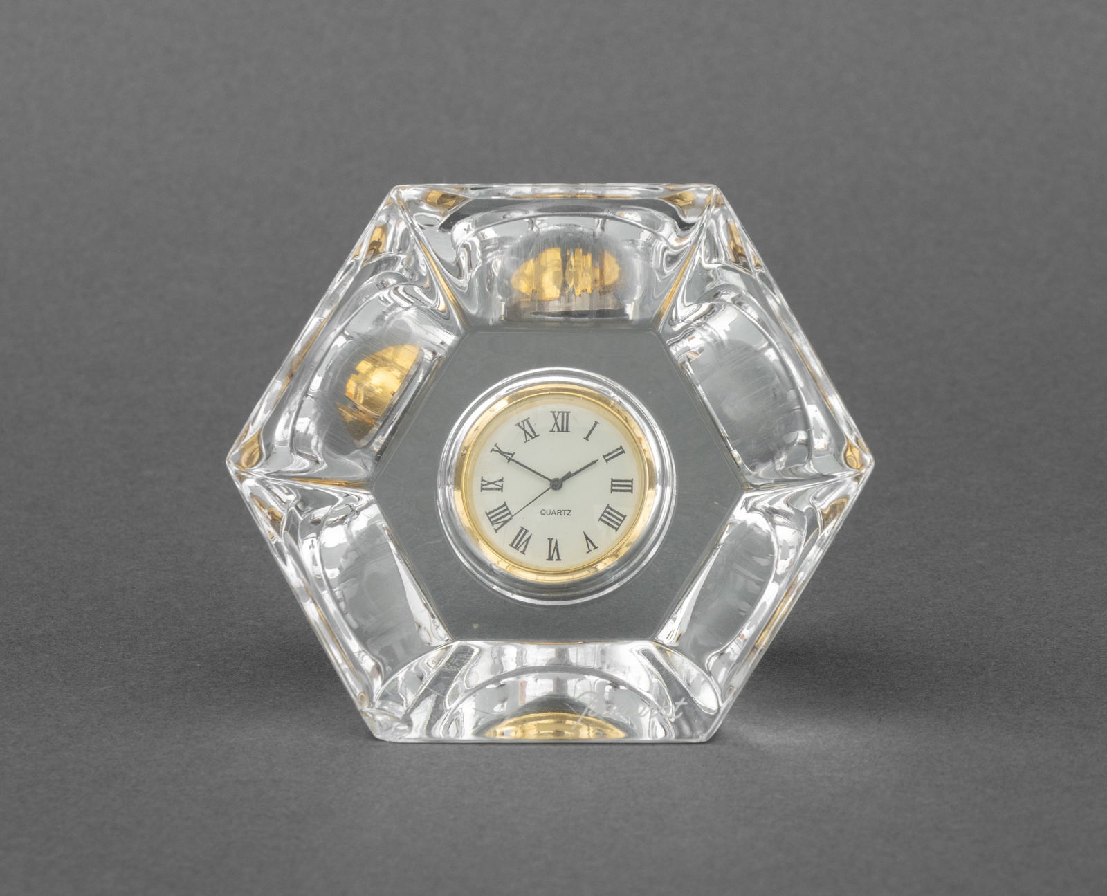Baccarat Crystal Hexagonal Desk Clock: Baccarat Crystal Hexagonal Desk Clock, marked "Baccarat" and acid-etched mark to the underside. 3.25" H x 3.75" W x 2" D. Provenance: From an East 74th Street Estate. Keywords: French cristal, Horloge