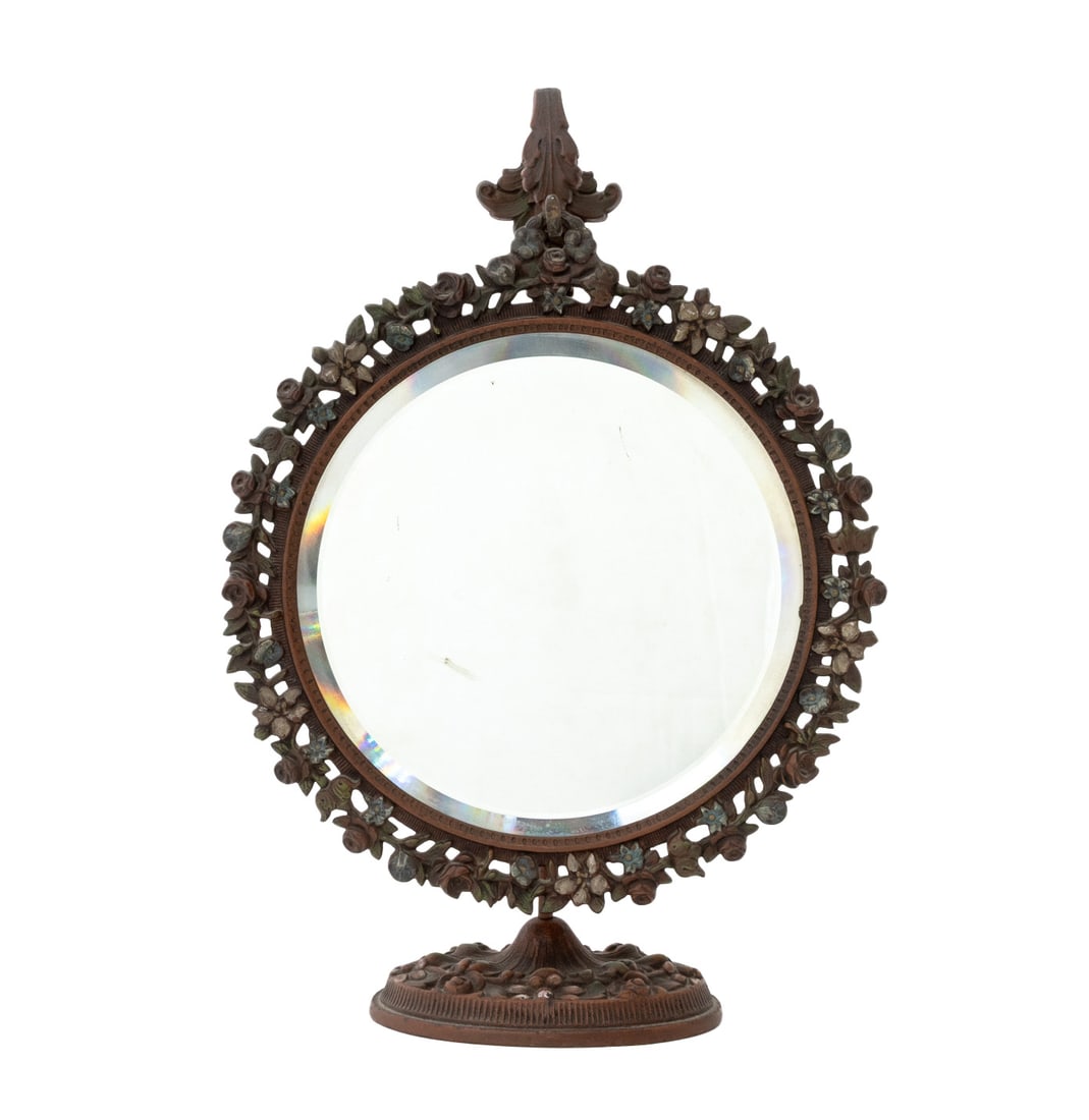 Victorian Cast Iron Vanity Mirror: Victorian Cast Iron Vanity Mirror, the beveled glass circular mirror plate in pierced rose trim frame hanging on free-standing pedestal hook. Overall: 14.5" H x 10" W x 4" D. Provenance: From an East