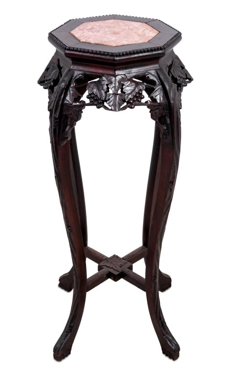 Chinese Hardwood and Marble Pedestal Table: Chinese Carved Hardwood and Marble Pedestal Table, early 20th century, the octagonal inset top above a foliate carved frieze on scrolled legs, joined by an X-stretcher. 36" H x 15" W x 15" D. Keywords