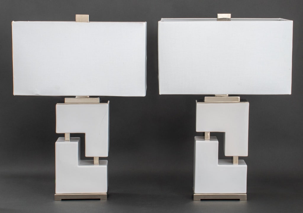 Contemporary White Geometric Table Lamps, Pair: Pair of Contemporary White Geometric Metal Table Lamps, on rectangular nickel-plated bases, marked "Uttermost" to light switch. 26.5" H x 7.5" W x 3.75" D; with shade: 18" W x 10" D. Provenance: From