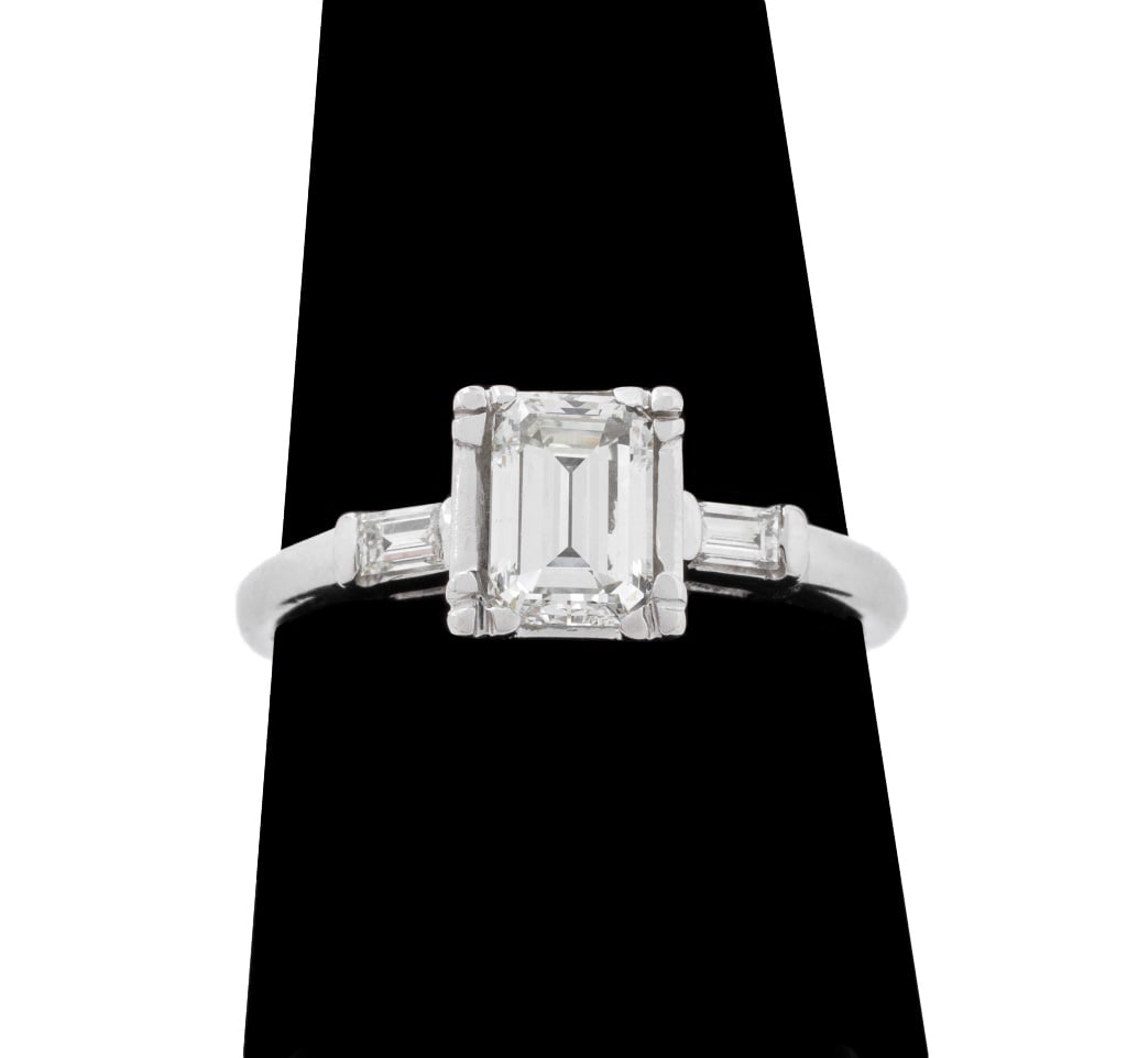14K White Gold Diamond Engagement Ring: 14K White Gold Engagement Ring, featuring one centered emerald cut diamond approx. 0.80 carat, F-G color and VS clarity, further adorned with two baguette diamonds weighing a total of approx. 0.18