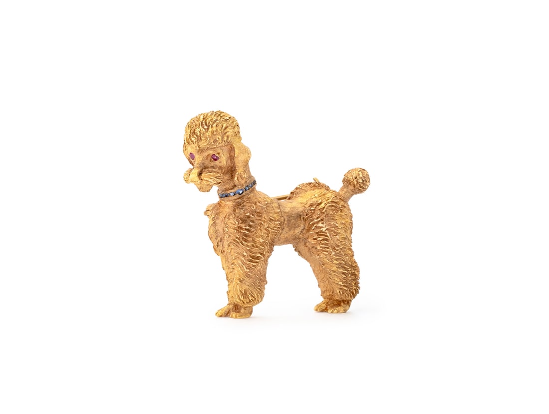 Tiffany & Co. 14K Gold Ruby Sapphire Poodle Brooch: Tiffany and Company 14K Yellow Gold Ruby Sapphire Poodle Form Brooch, designed as a French cut poodle dog with ruby eyes and sapphire collar, featuring two flush set round faceted rubies and seven