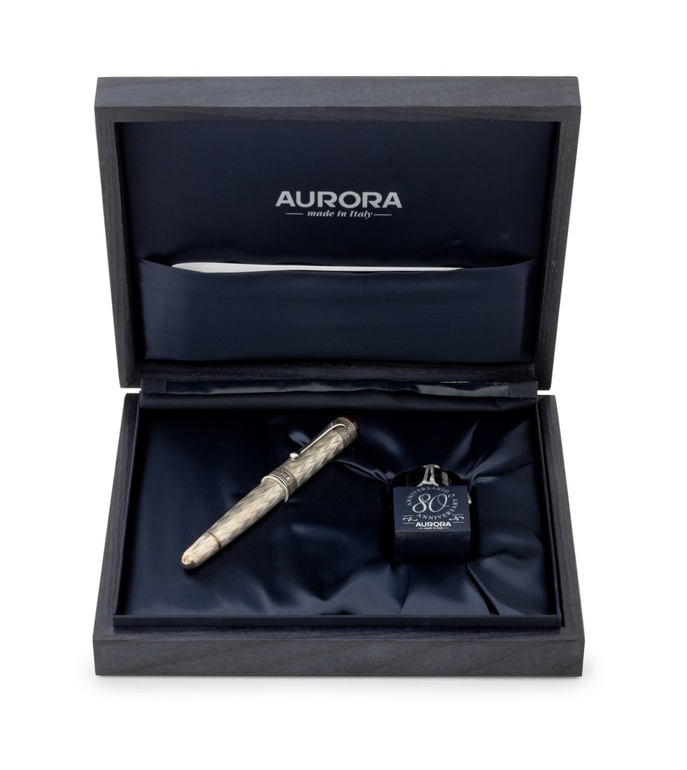 Aurora 80th Anniversary Silver Fountain Pen, 1999: Aurora 80th Anniversary Sterling Silver Fountain Pen, 1999, sterling silver and Bordeaux resin, "flame" guilloche with high relief decoration, rhodium-treated 18K gold nib marked "18K / 750 / Aurora",