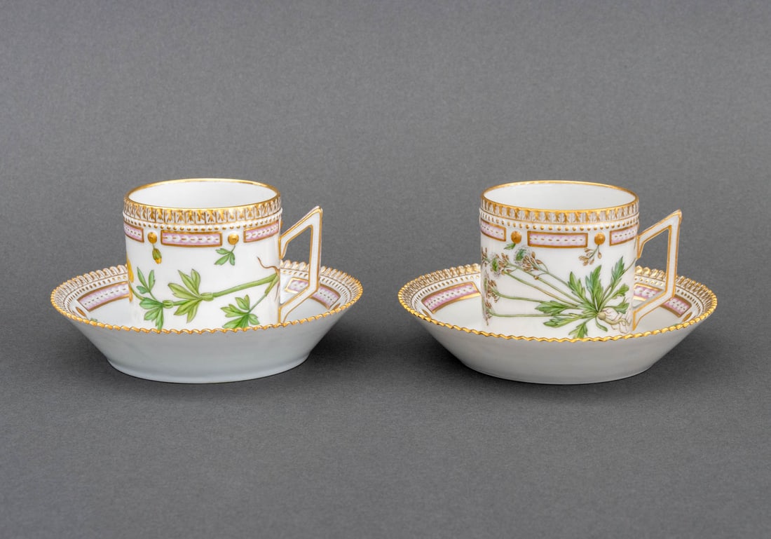 Royal Copenhagen "Flora Danica" Teacups, Pair: Pair of Royal Copenhagen "Flora Danica" Porcelain Teacups and Saucers, marked "Ranunculus vivalis L. / Royal Copenhagen / Denmark" and numbered "20/3573" to underside. Overall: 3" H x 5.25" Diameter.