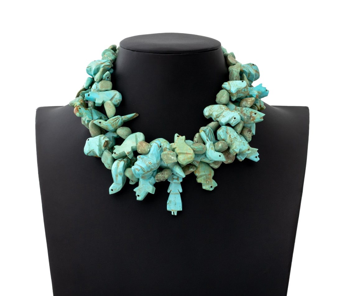 Navajo Dine Carved Turquoise Fetish Necklace: Navajo Dine Carved Turquoise Fetish Necklace, three strands of carved animals including birds, turtles, fish, and other animals, with silver enclosures and clasp marked "Sterling". 8.5" L x 3" W.