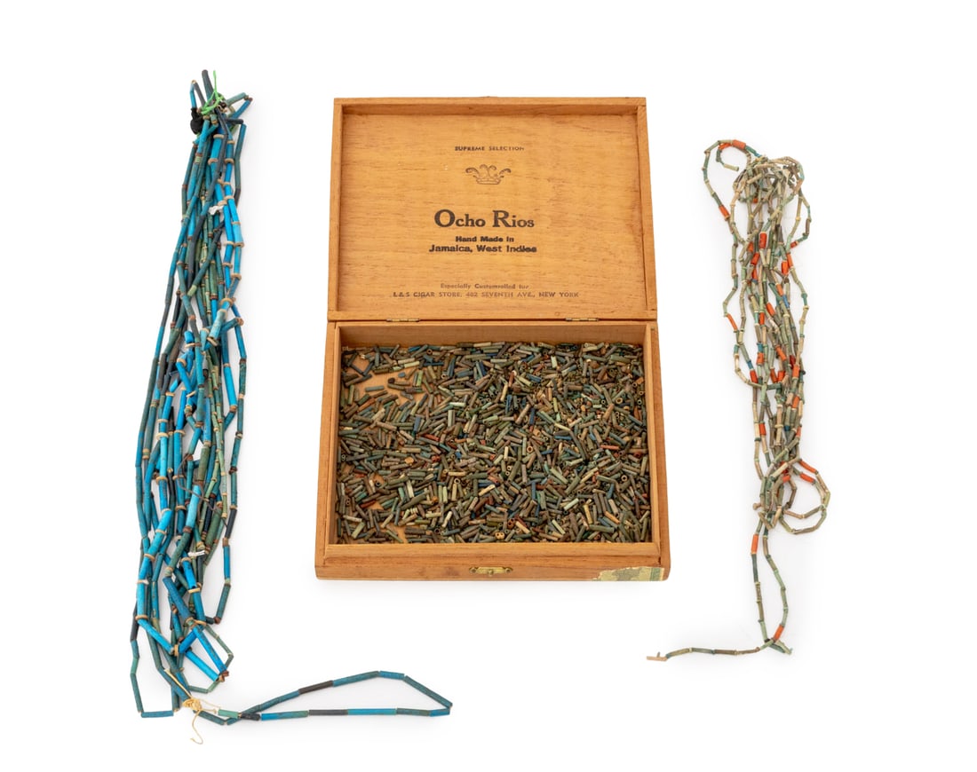 Collection of Egyptian Faience Beads: Collection of Egyptian Faience Beads, some turquoise blue glazed, one strand with cylindrical red coral beads, together with wood box. Box: 6.75" L x 8.25" W x 1.5" D. Provenance: From the Estate of J