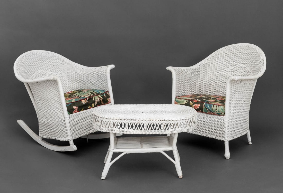 Vintage White Wicker Furniture Set, 3 Pcs.: Vintage White Wicker Three-Piece Furniture Set, comprising: a rocking chair and armchair with bird and botanical print fabric cushions and a coffee table. Taller chair: 32.5" H x 29.5" W x 35.5" D; se