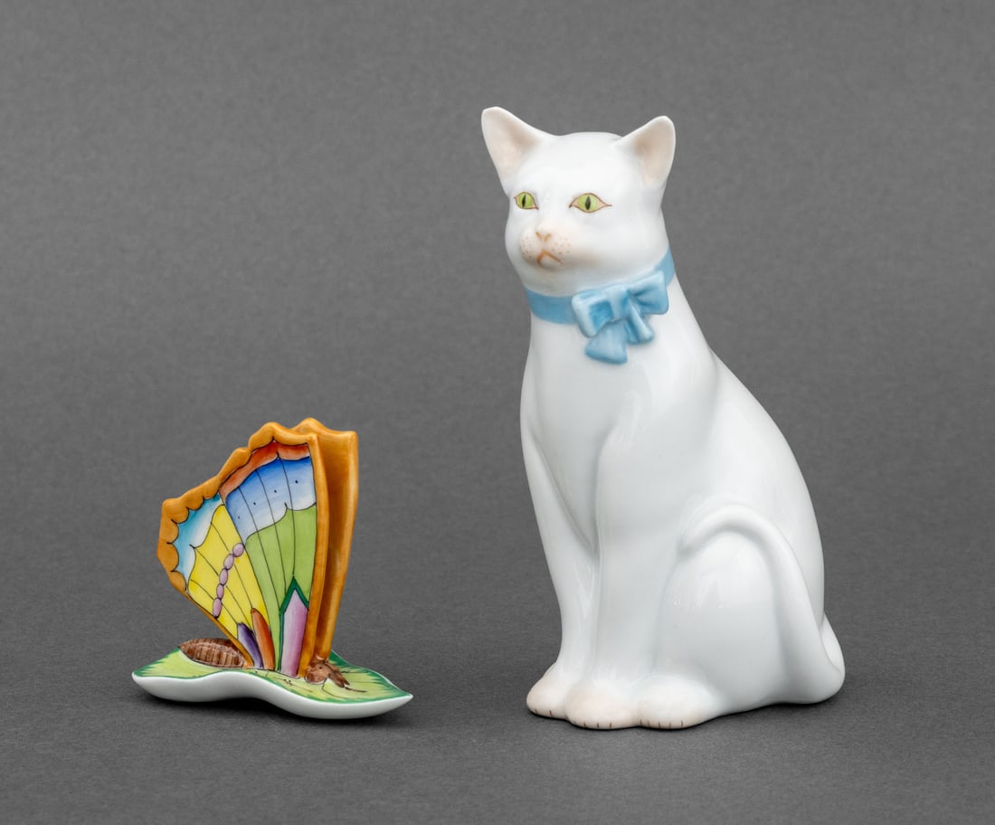 Herend Cat and Butterfly Porcelain Figurines, 2: Group of Two Herend Cat and Butterfly Porcelain Figurines, each marked "Herend Hungary / Handpainted" underside, comprising: White cat with blue ribbon and colorful butterfly on leaf. Cat: 4.5" H x 2"