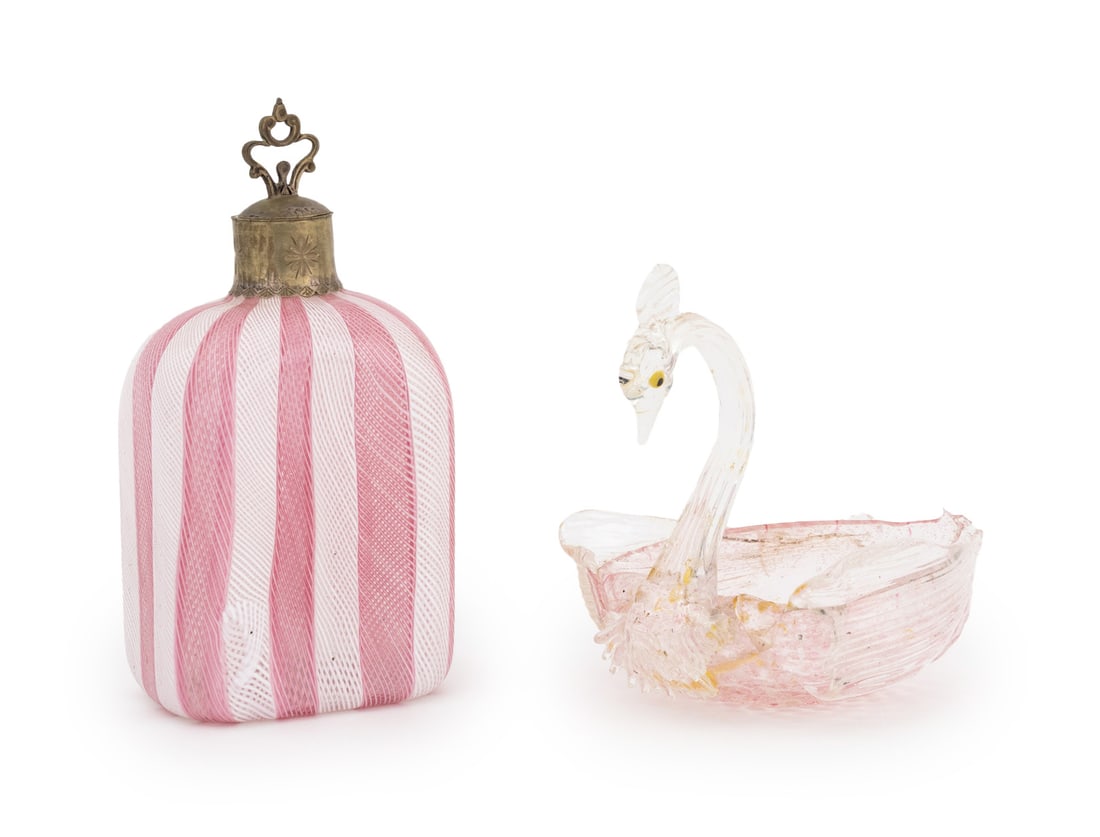 Murano Pink Art Glass Vanity Accessories, 2: Two Murano Pink Art Glass Vanity Accessories, comprising: pink and white latticino glass perfume bottle with silver plate lid and swan form jewelry dish with silver leaf flecks. Taller: 7" H x 3.5" W