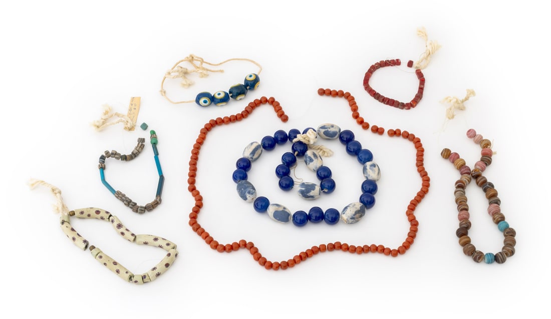 Collection of Venetian Glass African Trade Beads: Collection of Venetian Glass African Trade Beads, including: Venetian millefiori glass trade beads, square red agate glass beads, red glass beads, and turquoise blue eye beads. Longest bead: 2.5" L x