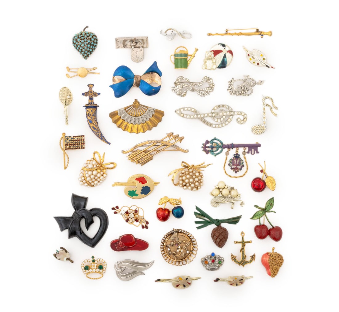 Trifari, Monet, Etc. Object Form Brooches, 40: Collection of 40 Vintage Object Form Brooches, comprising: a Kenneth J. Lane lock form marked "KJL", a Crown Trifari silver-tone swirl, a Monet bow form, an Austrian red cherry, an artist's palette fo