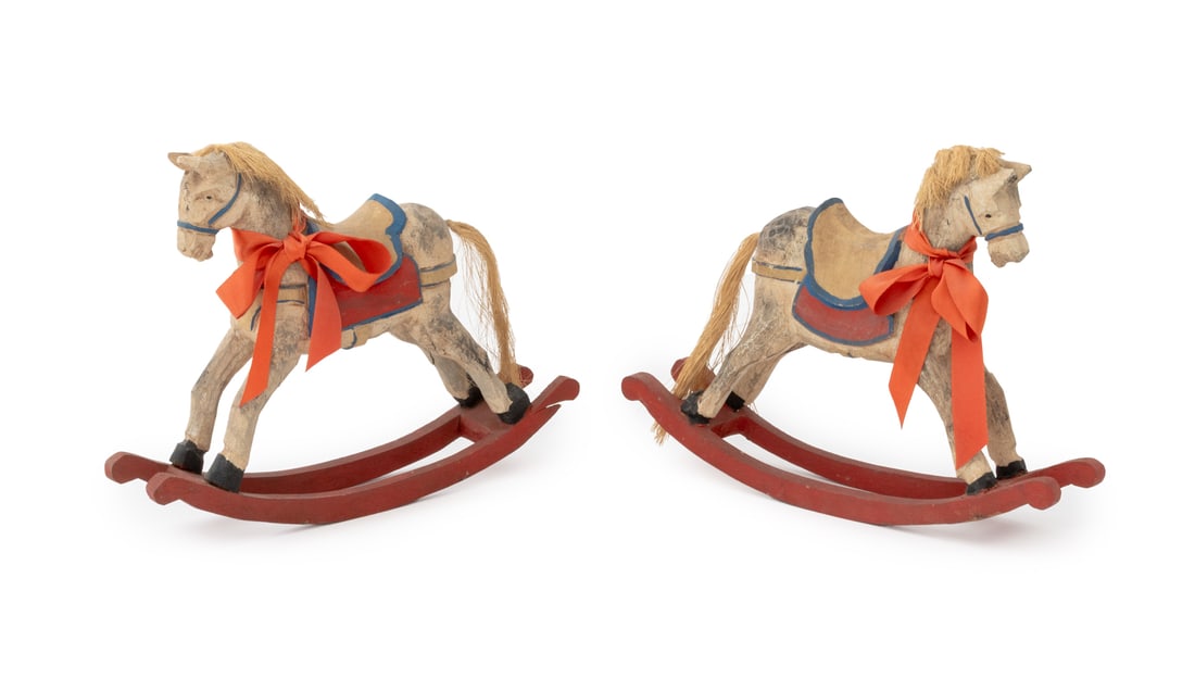 Folk Art Carved Polychromed Wood Rocking Horses, 2: Pair of Folk Art Polychrome Painted and Hand-Carved Wood Rocking Horses. 10.75" H x 14.25" W x 3" D. Provenance: From an East 74th Street Estate. Keywords: Carvings, Statues, Sculptures, Toys, Equestr