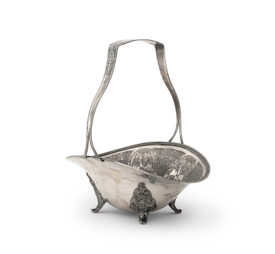 Wilcox Silver Plate Floral Centerpiece Basket: Wilcox Silver Plate Floral Centerpiece Basket, with fixed handle on four scroll feet, marked "Wilcox S.P. Co. / International" to underside. 11.5" H x 10.75" W x 8.5" D. Provenance: From an East 74th