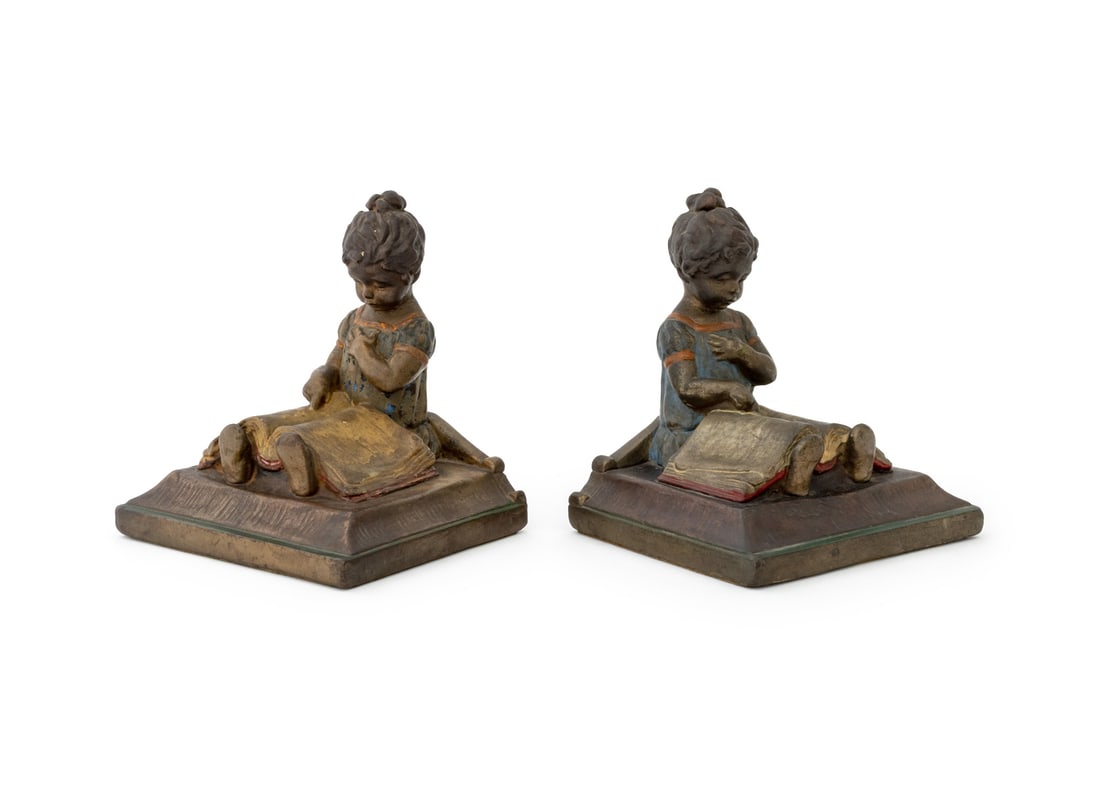 Art Nouveau Bronze Clad Figural Bookends, Pair: Pair of Art Nouveau Bronze Clad Figural Bookends, depicting a girl reading a book, "The Armor Bronze Company" label to underside. 6.5" H x 5.75" W x 5.25" D. Provenance: From an East 74th Street