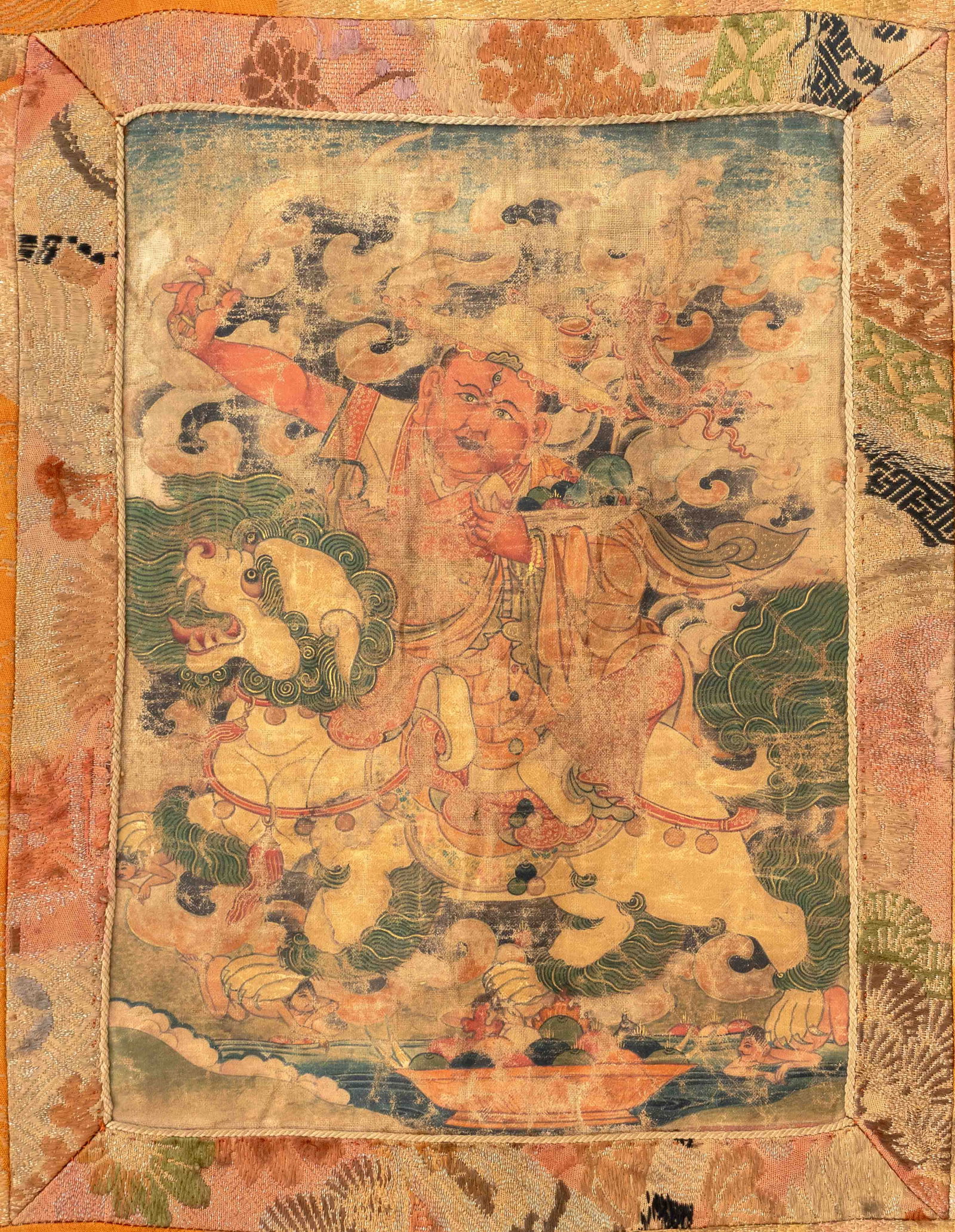Chinese Tibetan Pehar Thangka, 18th C.: Chinese Tibetan Pehar Thangka, Gouache on Cloth, 18th century, mounted on silk, depicting Pehar riding a lion. Image: 9.75" H x 7.25" W; overall: 23" H x 16.75" W. Provenance: From the Estate of Josep
