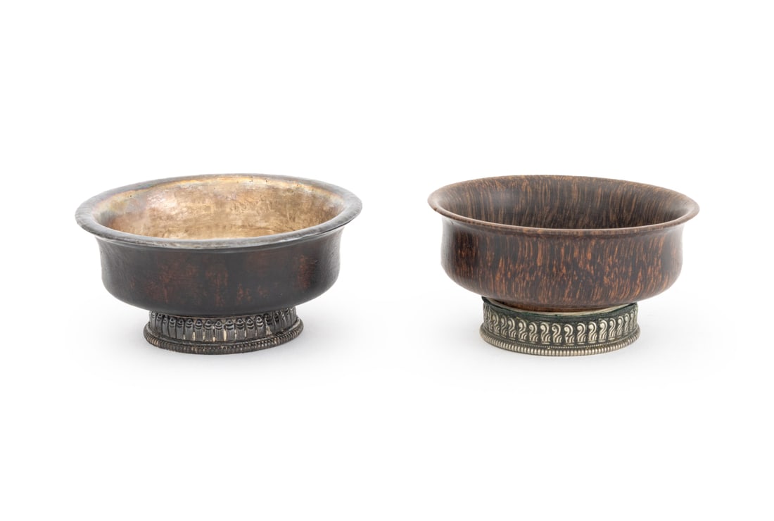 Tibetan Burlwood Jha-Phor Tea Bowls, 2: Two Tibetan Burl Wood Jha-Phor Tea Bowls, 19th century, one with silver liner and silver mounted base and one with silver plate mounted base. Larger: 1.75" H x 3.75" Diameter. Provenance: From the Est