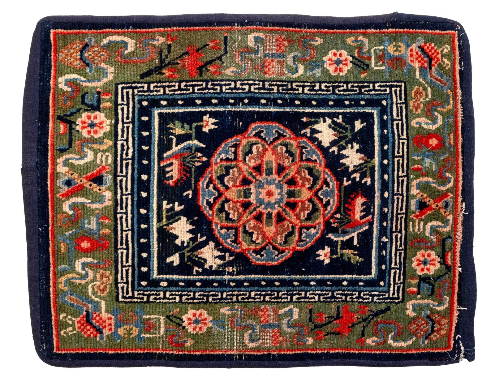 Tibetan Saddle Rug, 2' 6" x 2' 2": TIbetan Wool Saddle Rug, with floral central medallion and geometric green border. 2' 6" L x 2' 2" W. Provenance: From the Estate of Joseph Lawrence Gardella. Keywords: Himalayan Art, Nepal, Asian Art