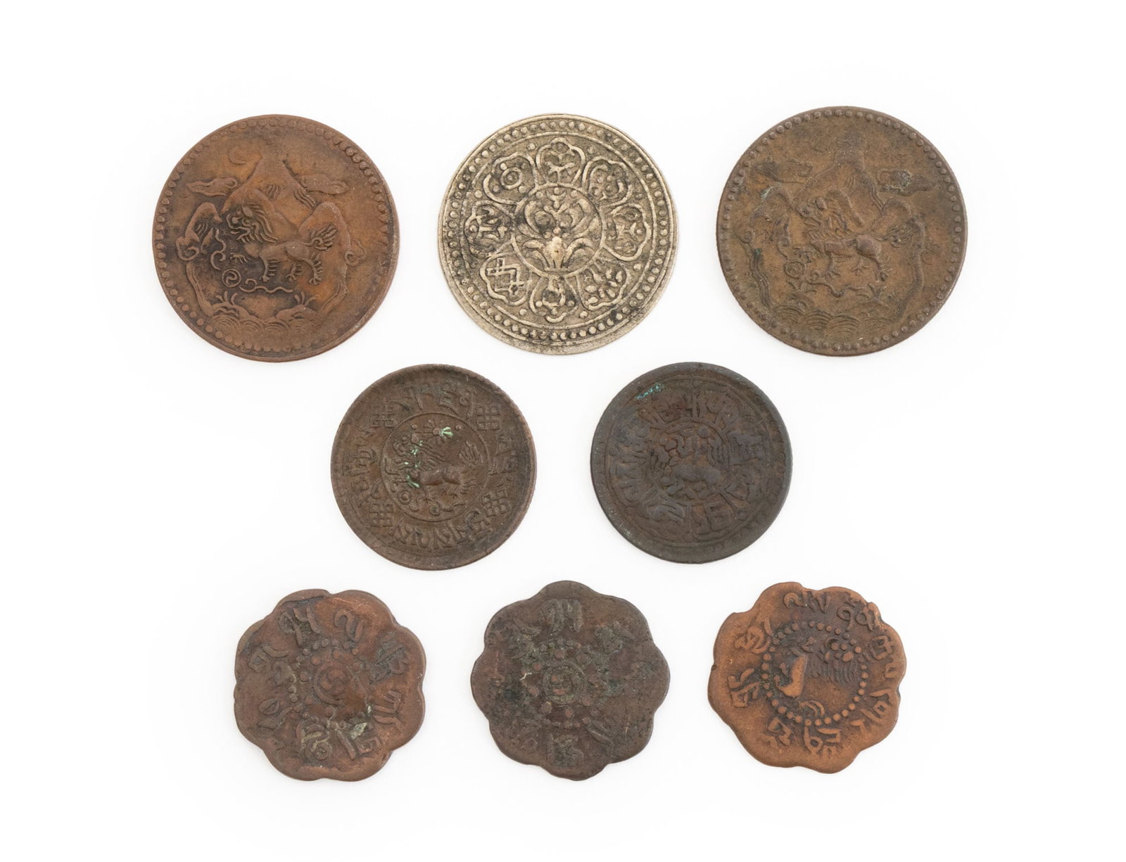 Tibetan Sho and Srang Coins, 8: Collection of Eight Tibetan Copper and Silver Plate Sho and Srang Coins, early 20th century. Largest: 1" Diameter. Provenance: From the Estate of Joseph Lawrence Gardella. Keywords: Numismatic, Coins