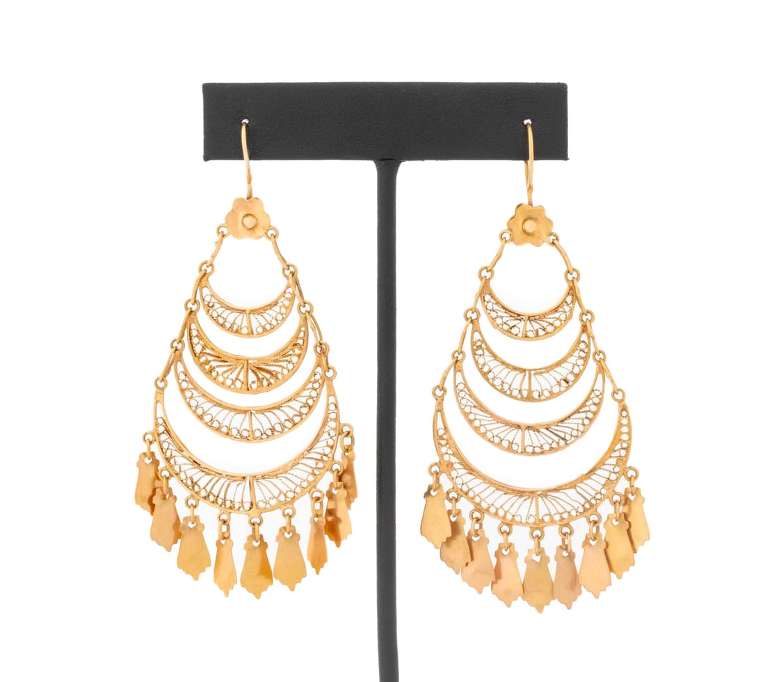 21K Yellow Gold Filigree Chandelier Earrings: Pair of 21K Yellow Gold Filigree Chandelier Earrings, designed with tapered crescent shaped openwork frames linked with oval wire links, bottom crescents decorated with miniature charm terminations,