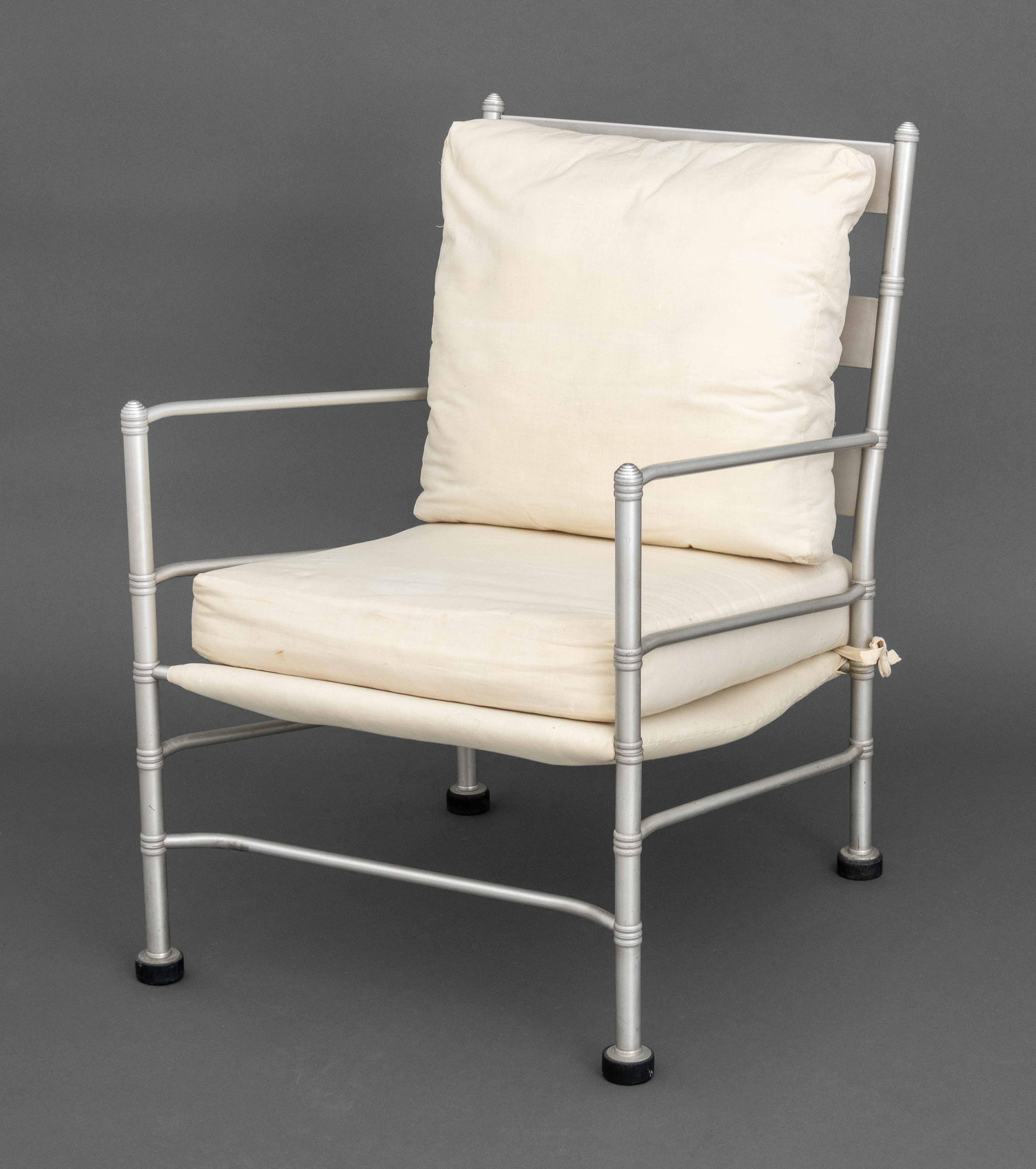 Warren McArthur Art Deco Easy Chair: Warren McArthur (American, 1885-1961) Art Deco Easy Chair, aluminum, Bakelite, and fabric upholstery. 34" H x 23" W x 28" D; seat 17" H. Provenance: From a New York City Collection. Keywords: Streamli