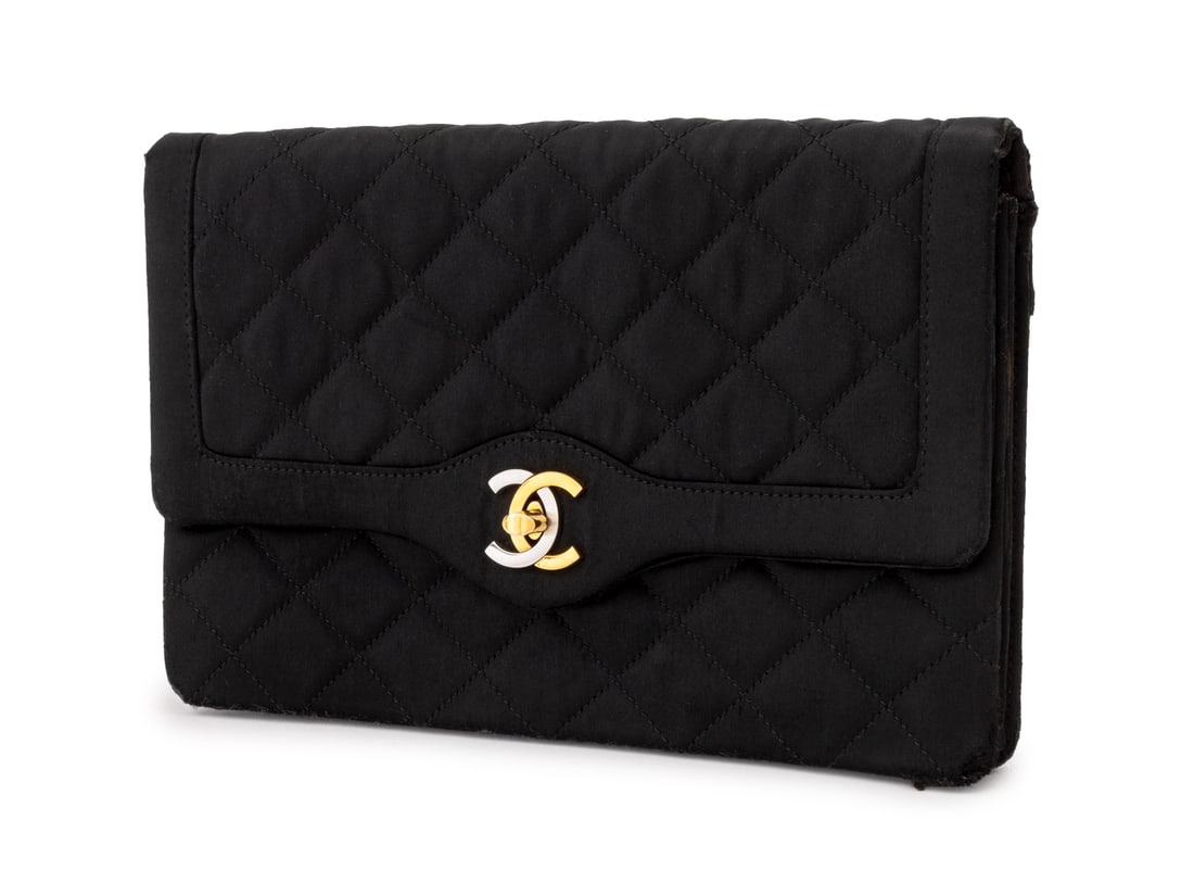 Chanel Quilted Black Satin Clutch: Chanel Quilted Black Satin Clutch, with double CC clasp closure, marked "Chanel / Paris" and "Made in France" inside. 6.25" H x 9.5 W x 1" D. Provenance: From the Collection of Laura and Lewis Kruger.